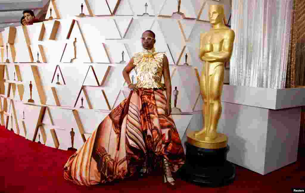 Billy Porter in Giles Deacon and shoes by Jimmy Choo poses on the red carpet during the Oscars arrivals at the 92nd Academy Awards in Hollywood, Feb. 9, 2020. 