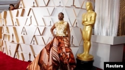 FILE - Billy Porter in Giles Deacon and shoes by Jimmy Choo poses on the red carpet during the Oscars arrivals at the 92nd Academy Awards in Hollywood, Los Angeles, February 9, 2020.