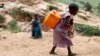 FILE - A girl carries a container of water at a coltan mine in Kamatare, Masisi territory, North Kivu Province of Democratic Republic of Congo, December 1, 2018. (REUTERS/Goran Tomasevic/File Photo)