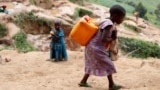 FILE - A girl carries a container of water at a coltan mine in Kamatare, Masisi territory, North Kivu Province of Democratic Republic of Congo, December 1, 2018. (REUTERS/Goran Tomasevic/File Photo)