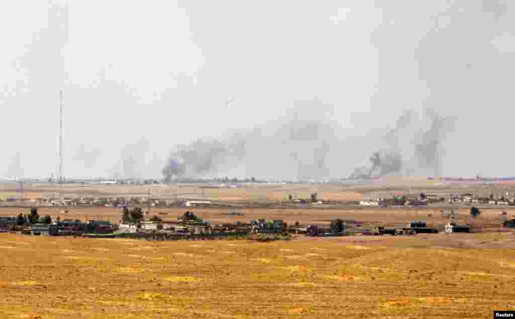 Smoke rises on the horizon&nbsp;after American air strikes,&nbsp;in Khazir, Sept. 16, 2014. 