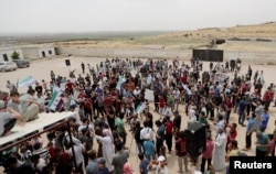 Displaced Syrians gather during a protest calling for an end to airstrikes, in Idlib province, Syria, May 31, 2019.