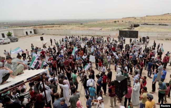 Displaced Syrians gather during a protest calling for an end to airstrikes, in Idlib province, Syria, May 31, 2019.