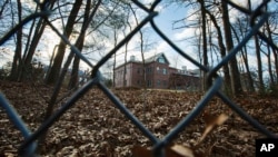 FILE - A fence encloses an estate in the village of Upper Brookville in the town of Oyster Bay, N.Y., on Long Island. The Obama administration closed this compound for Russian diplomats, in retaliation for spying and cyber-meddling in the U.S. presidential election. 