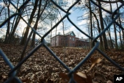 FILE - A fence encloses an estate until recently used by Russian diplomats in Upper Brookville, New York, Dec. 30, 2016. The administration of then president Barack Obama closed the compound in late 2016 in retaliation for what it said was Russia's meddling in the U.S. presidential election.