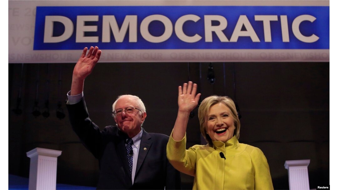 Democratic U.S. presidential candidates Senator Bernie Sanders and former Secretary of State Hillary Clinton arrive on stage ahead of the start of the PBS NewsHour Democratic presidential candidates debate in Milwaukee, Wisconsin, Feb. 11, 2016.