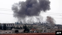 FILE - Smoke billows following Syrian government forces' bombardment around the town of Al Habit on the southern edges of the rebel-held Idlib province, Sept. 9, 2018. 