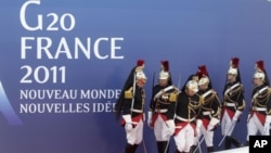 People walk down a stairway at the G20 press center in Cannes, France on Wednesday, Nov. 2, 2011.