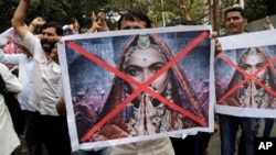 Members of a Hindu organization carry posters and shout slogans against the release of the Bollywood film "Padmaavat" near the office of Central Board of Film Certification (CBFC) in Mumbai, India, Friday, Jan. 12, 2018. The film has been in trouble since early last year, with fringe groups in the western state of Rajasthan attacking the film's set, threatening to burn down theaters that show it and even physically attacking the director in Jan. 2017. CBFC has given a go ahead for the release of the film after suggesting change in title from Padmavati to Padmaavat. (AP Photo/Rajanish Kakade)