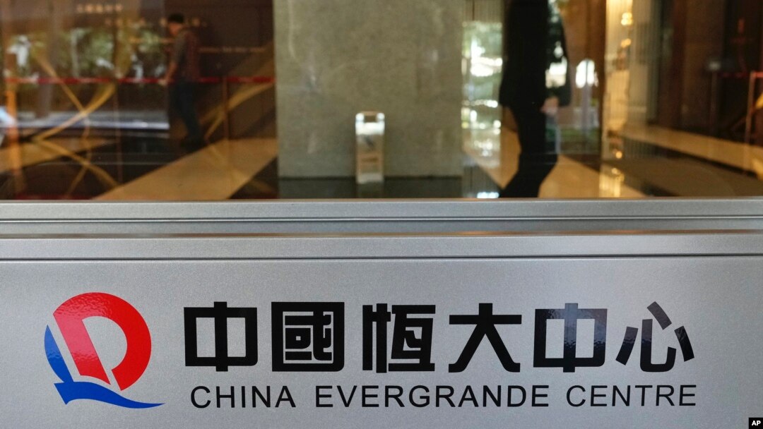 FILE - A security guard stands at the headquarters of China Evergrande Group, Oct. 4, 2021, in Hong Kong. 