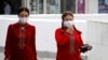 Turkmen women wearing face masks walk in Ashgabat on July 13, 2020. Reclusive Turkmenistan on July 13 recommended that residents wear masks because of "dust" even as the government insists the country is coronavirus-free.