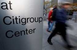 FILE - People walk past the Citigroup building, in New York.