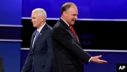 Republican vice-presidential nominee Gov. Mike Pence and Democratic vice-presidential nominee Sen. Tim Kaine, right, walk past each other after the vice-presidential debate at Longwood University in Farmville, Va., Tuesday, Oct. 4, 2016.