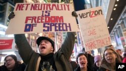 Demonstrators rally in support of net neutrality outside a Verizon store, Dec. 7, 2017, in New York. 