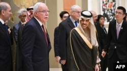 FILE Saudi Arabia's Foreign Minister Prince Faisal bin Farhan Al-Saud (R) and Palestinian Foreign Minister Riyad al-Maliki (L) meet with China's Foreign Minister Wang Yi and foreign ministers from Muslim-majority nations in Beijing on November 20, 2023. 