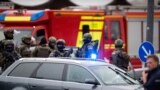 Policemen arrive at a shopping mall following shootings on July 22, 2016 in Munich.