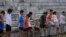 FILE - Youths attend a daily track-and-field class, part of a training course at the Jinshan Youth Spare-time Sports School, in Shanghai, Aug. 25, 2015. About 30 youths are enrolled and top performers will be groomed to become professional athletes.
