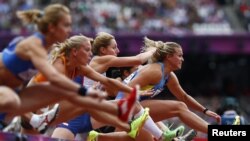 Natallia Dobrynska (R) of Ukraine, leads the field as she competes in her women's heptathlon 100m hurdles heat during the London 2012 Olympic Games at the Olympic Stadium August 3, 2012.