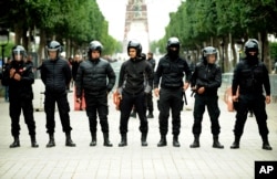 Tunisian riot police officers line up during a protest against the 2018 budget in Tunis, Jan. 9, 2018.