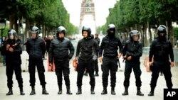 Tunisian riot police officers line up during a protest against the 2018 budget in Tunis, Jan. 9, 2018. 