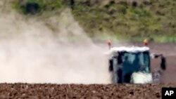 The hot air shimmers in front of a tractor during a long time of drought near Bad Lauchstaedt, Germany, April 27, 2020. 