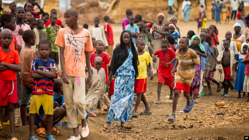 FILE - Refugees are seen gathered at Minawao Refugee Camp in northern Cameroon, April 18, 2016. The U.N. refugee agency has called on Cameroon to stop forcibly repatriating Nigerians refugees on its territory. 