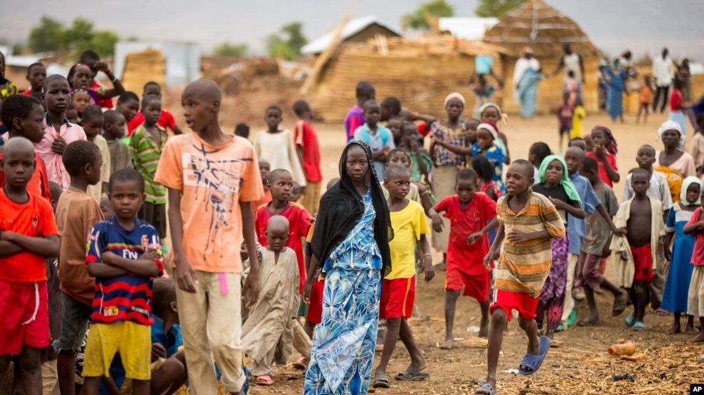 FILE - Refugees are seen gathered at Minawao camp in northern Cameroon, April 18, 2016. The U.N. refugee agency has called on Cameroon to stop forcibly repatriating Nigerian refugees on its territory. 