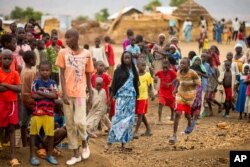 FILE - Refugees are seen gathered at Minawao Refugee Camp in northern Cameroon, April 18, 2016. The U.N. refugee agency has called on Cameroon to stop forcibly repatriating Nigerians refugees on its territory.