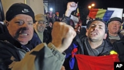 Demonstrators shout slogans during a protest against the government at the University Square in central Bucharest, Romania, January 23, 2012.