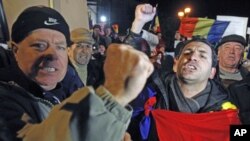 Demonstrators shout slogans during a protest against the government at the University Square in central Bucharest, Romania, January 23, 2012.