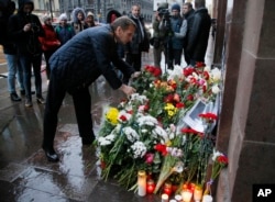 Sergei Naryshkin, speaker of the State Duma, lower parliament chamber, lays flowers in front of the French consulate in St.Petersburg, Russia,for the victims of the Paris attacks on Friday, Nov. 14, 2015.