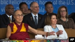 FILE - Tibetan spiritual leader Dalai Lama holds the arm of U.S. House Minority Leader Nancy Pelosi at the Tsuglagkhang temple in Dharmsala, India, May 10, 2017.