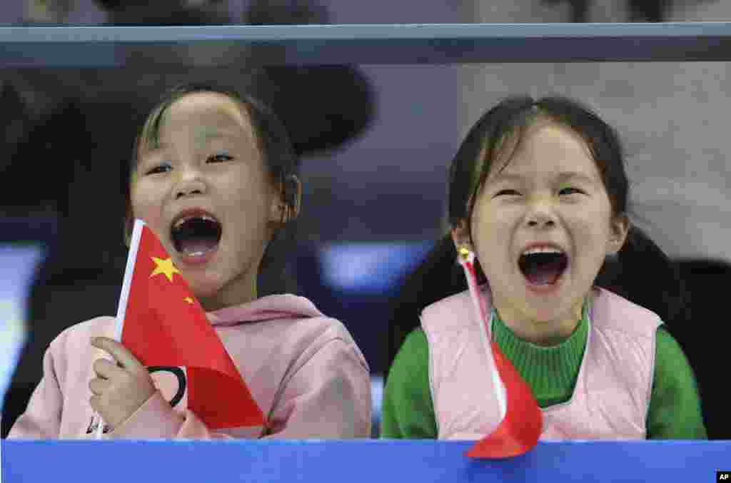Chinese girls cheer as they watch the 14th FINA World Swimming Championships in Hangzhou, China.