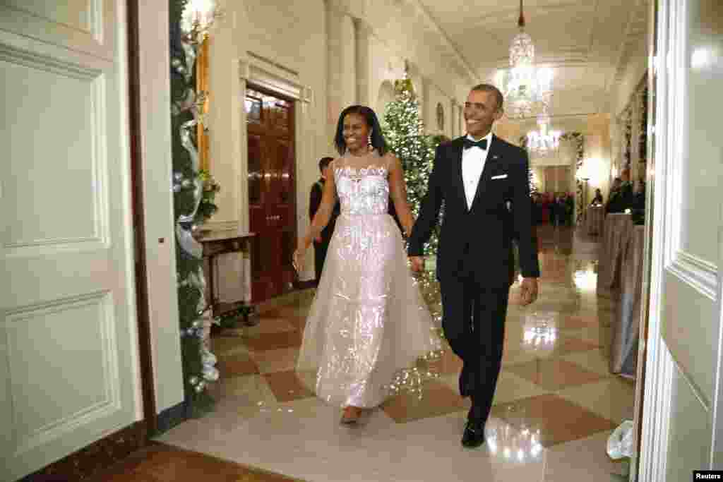 U.S. President Barack Obama and first lady Michelle Obama arrive for a reception for 2014 Kennedy Center honorees in the East Room at the White House, Dec. 7, 2014.
