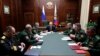 Russian President Vladimir Putin, center, leads a meeting with top military officers in the National Defense Control Center in Moscow, Dec. 24, 2019.