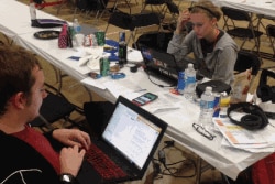 Tyler Skluzacek and another team member at a competition called HackDC, a coding competition, teamed up with other participants to create the myBivy smartphone/smartwatch application, in Washington, D.C. (Courtesy photo / T. Skluzacek)