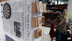 In this Sunday, Sept. 3, 2017, The first issue of The Cambodia Daily is seen at the newspaper's office, in Phnom Penh, Cambodia. When Cambodia’s main opposition leader was arrested over the weekend in a surprise police raid, one of this country’s last independent media outlets rushed reporters out in the middle of night to cover the story, just as it has done for nearly a quarter-century. But the English-language Cambodia’s Daily’s reportage about the arrest of Kem Sokha, who stands accused by the government of treason, was a tragic story in and of itself: It was on the front page of the paper’s final issue Monday, Sept. 4. (AP Photo/Heng Sinith)