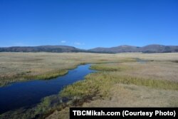 At Valles Caldera National Preserve in New Mexico, lush green meadows and a clear blue stream paint a deceptive picture of a landscape that was once the site of a massive volcanic eruption.