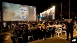 President Barack Obama, on a video monitor, addresses the gathering during a rally in Tel Aviv, Israel, marking 20 years since the assassination of former Israeli Prime Minister Yitzhak Rabin, Oct. 31, 2015.
