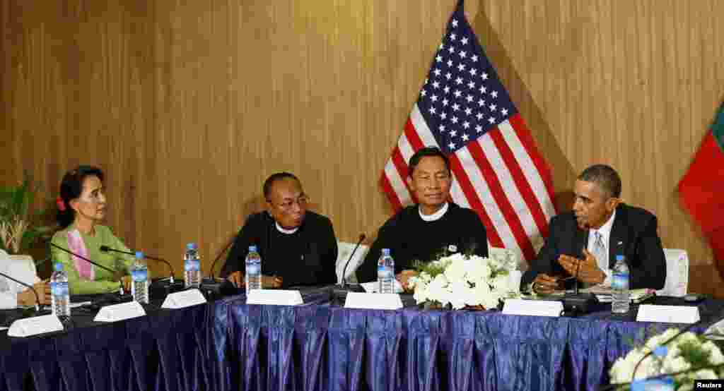 U.S. President Barack Obama speaks toward Myanmar opposition leader Aung San Suu Kyi, left, during a roundtable with members of parliament and civil society to discuss Myanmar&#39;s reform process in Naypyitaw, Nov. 13, 2014.