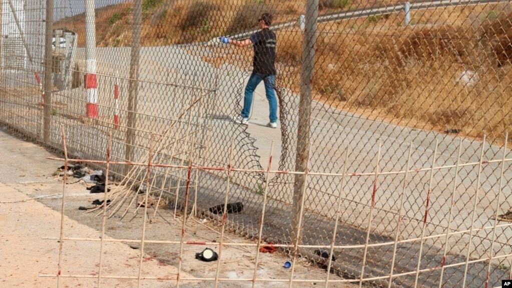 Image released by the Spanish Guardia Civil on Aug. 22, 2018 shows damage done to a fence dividing the Spanish enclave of Ceuta and Morocco.