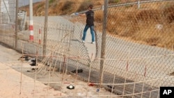 Image released by the Spanish Guardia Civil on Aug. 22, 2018 shows damage done to a fence dividing the Spanish enclave of Ceuta and Morocco.