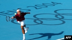  In this file photograph taken on August 17, 2004, Switzerland's Roger Federer lunges to reach a ball in his men's singles match against Czech Republic's Tomas Berdych tournament of the 2004 Olympic Games in Athens.