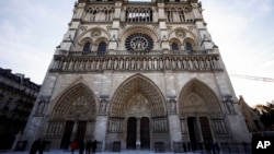 People stand outside Notre Dame cathedral in Paris on Nov. 29 2024. 