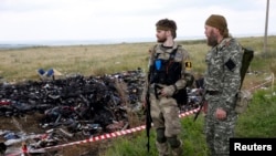 Armed pro-Russian separatists guard the crash site of Malaysia Airlines Flight MH17 in Donetsk region July 22, 2014. 