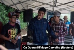 Indigenous rap group Oz Guarani sings during the event "Culture and Concept" at indigenous community Tekoa Itakupe in the city of Sao Paulo, claiming for land demarcation, Oct. 22, 2017.