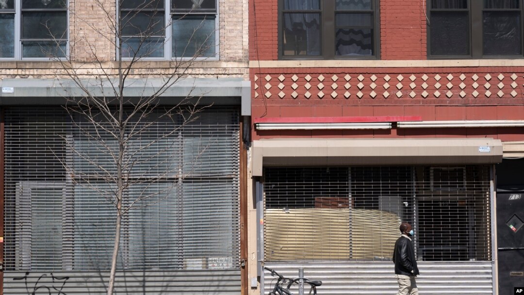 FILE - Two storefronts are empty in New York, April 5, 2021. 