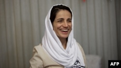 FILE - Iranian lawyer Nasrin Sotoudeh smiles at her home in Tehran, Sept. 18, 2013, after being freed following three years in prison. Iranian security agents re-arrested Sotoudeh at her home on June 13, 2018. 