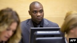 FILE - Germain Katanga, a Congolese National, sits during his trial at the International Criminal Court (ICC) in the Hague, May 23, 2014.