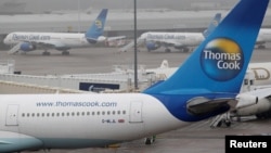 FILE - Thomas Cook aircraft are seen parked on the tarmac at Manchester airport in Manchester, Britain, Nov. 22, 2011.